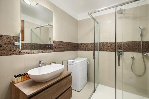a bathroom with a sink and a shower at Holiday Home Fažana 1931 in Fažana