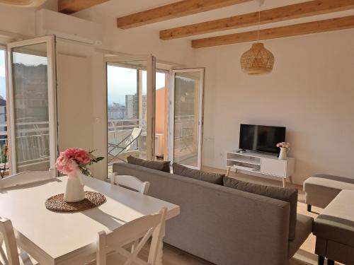 a living room with a couch and a table at Attico Saluzzo centro 2 in Saluzzo