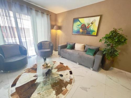 a living room with a couch and a table at Apart Teranga Dakar Plateau in Dakar