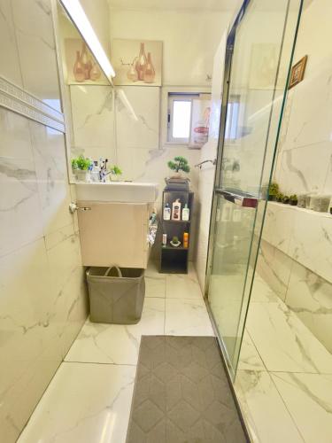 a bathroom with a shower and a sink at Apart Teranga Dakar Plateau in Dakar