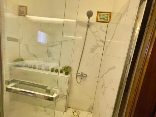 a shower with a glass door in a bathroom at Apart Teranga Dakar Plateau in Dakar
