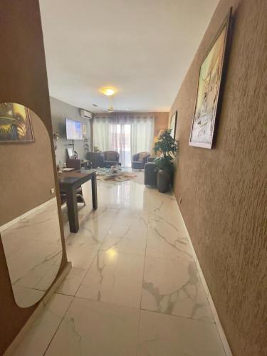 a living room with a large tile floor and a living room at Apart Teranga Dakar Plateau in Dakar