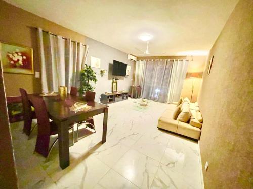 a living room with a table and a couch at Apart Teranga Dakar Plateau in Dakar