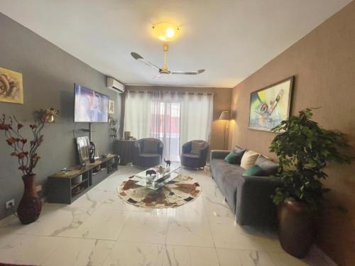 a living room with a couch and a table at Apart Teranga Dakar Plateau in Dakar
