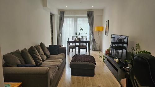a living room with a couch and a table at Gallions Reach - One Bed Flat in Beckton