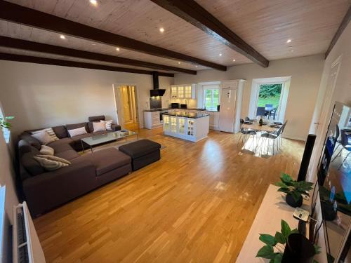 a living room with a couch and a table at Dragsgaard Herregård in Bælum