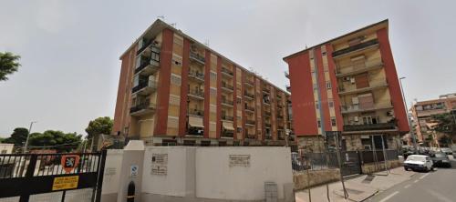 a building is under construction on a city street at Policlinic House Messina in Messina
