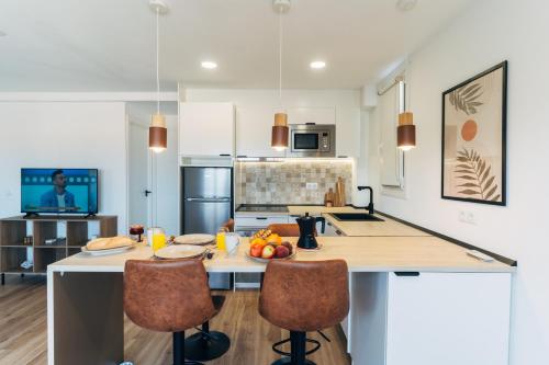 a kitchen with a large island with a counter top at Almare Suites - Aguadulce Vistas al mar in Aguadulce