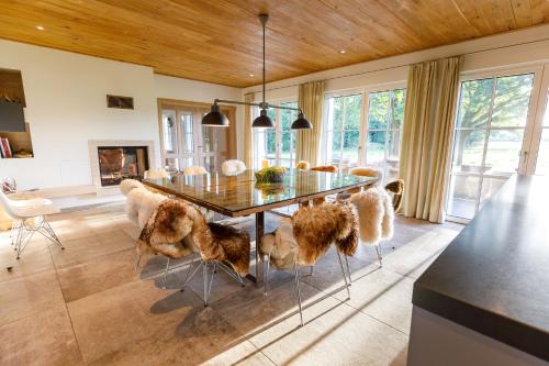 a dining room with a glass table and chairs at Spreewald Chalet in Burg