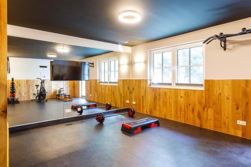 a gym with several dumbbells in a room at Spreewald Chalet in Burg