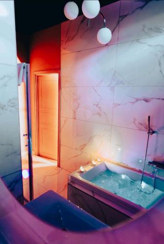a large bathroom with a tub and a mirror at Maison du Roi in Liège