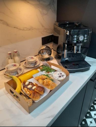 a table with a box of food on a counter at Maison du Roi in Liège