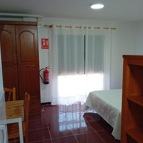 a bedroom with a bed and a window at APAR MARI 2c in Las Lagunas