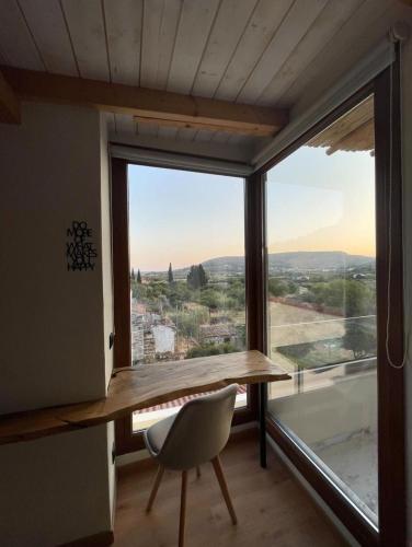 a desk in a room with a large window at Serenity in Samos