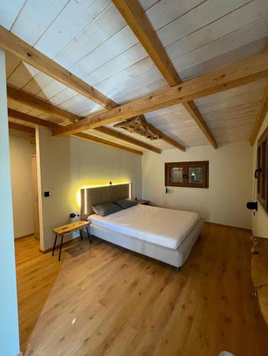 a large bedroom with a large bed and wooden floors at Serenity in Samos