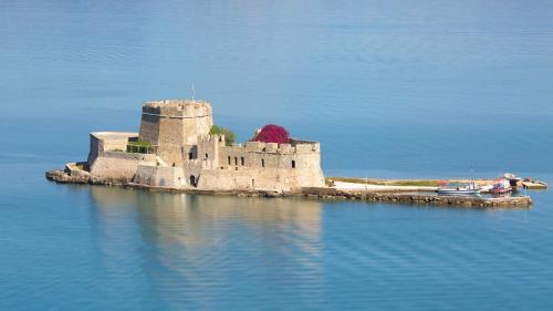 an island with a castle in the middle of the water at Lefka's Villas in Vivari