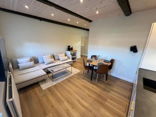 a living room with a couch and a table at Luxurious apartment in Manor House in Bælum