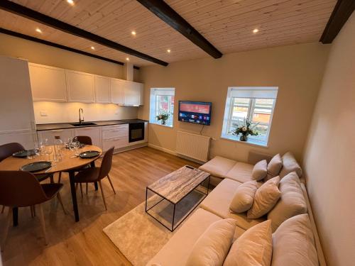 a large living room with a couch and a table at Luxurious apartment in Manor House in Bælum