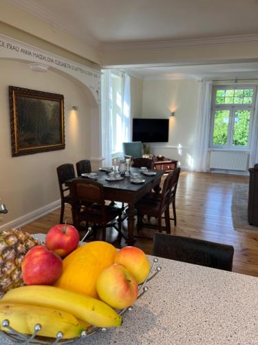 a living room with a table with fruits on a table at Wohnung im Schloss in Steinburg