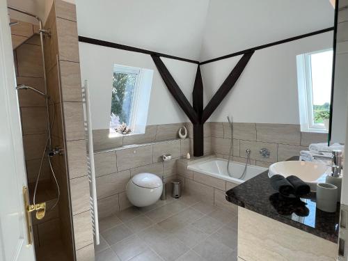 a bathroom with a tub and a toilet and a sink at Wohnung im Schloss in Todendorf