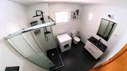 a bathroom with a toilet and a sink and a mirror at Alojamientos Turísticos TURBON - Campo in Campo