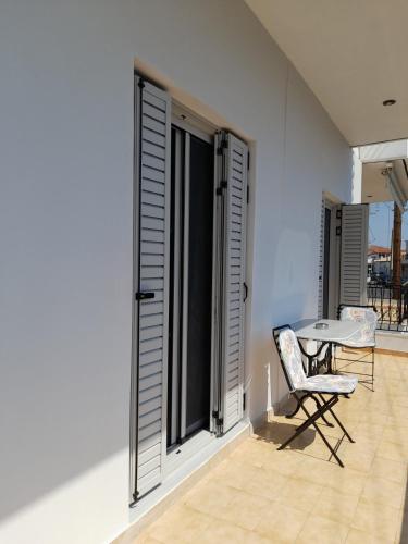 a room with a table and a chair and a window at Spacious house near the beach in Petalidhion