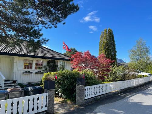a white picket fence in front of a house at Fjordhus in Austerheim