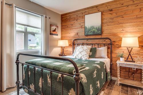 a bedroom with a bed and a window at Tranquil Lakefront Cabin Fire Pit, Grill and Patio in Tomahawk