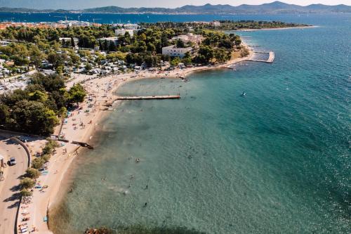 an aerial view of a beach with people in the water at Adria Concept Suites in Zadar