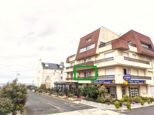 a building on the side of a street at Appartement vue mer et plage Saint-Aubin-Sur-Mer Normandie in Saint-Aubin-sur-Mer