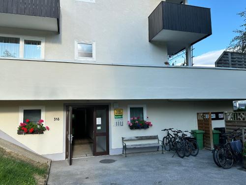 a building with bikes parked outside of it at Das Alpenzeit Loft mit Balkon und Grimmingblick in Bad Mitterndorf
