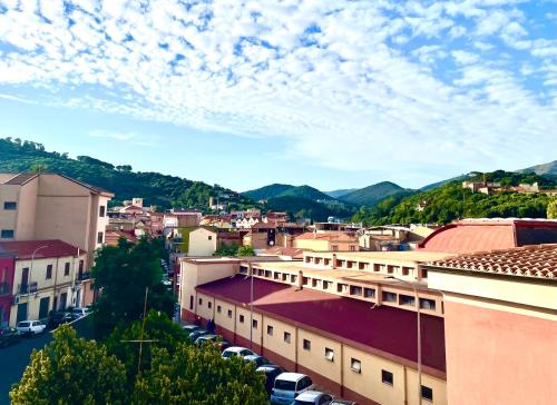 a city with cars parked in a parking lot at Casa vacanze i Giardini Iglesias in Iglesias