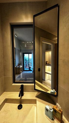 a bathroom with a sink with a large mirror at Samothraki Kaviri Boutique Residence in Samothraki