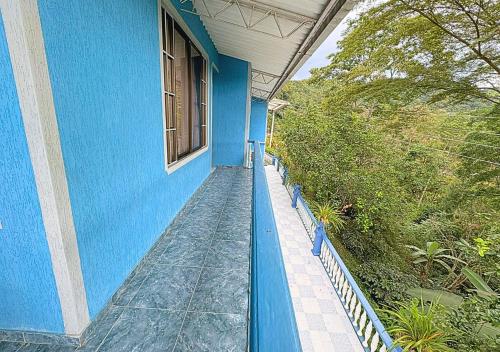 a blue house with a blue wall and a window at VillaLoren in San Antonio del Tequendama