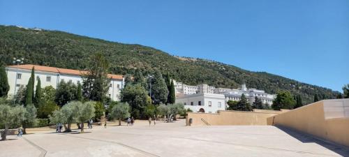 a large white building with a mountain in the background at PROF OLIVETO ANTICo in San Marco in Lamis