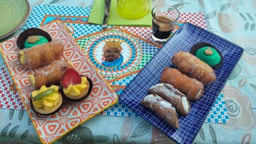 a table with two plates of food with a picture of the pope at casa carmelo in Schio