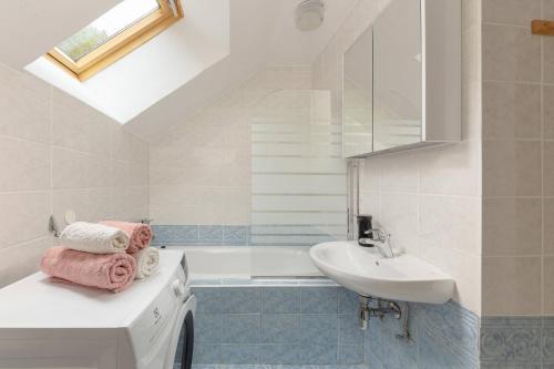a bathroom with a sink and a bath tub at Fine Stay Apartments in Žirovnica