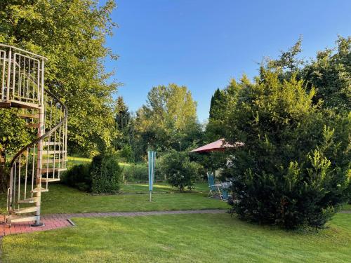 a garden with a swing set and a playground at Wohnung mit Gartenblick in Hofgeismar