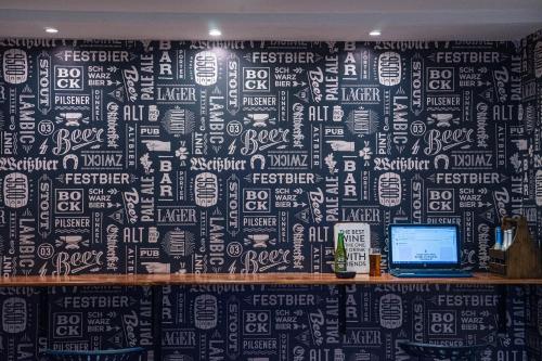 a black and white wall with a laptop on a desk at La Félicité Hostel in Salta