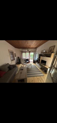 a living room with a couch and a piano at Rustik in Soko Banja