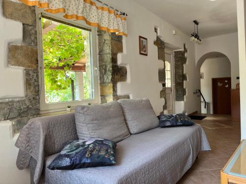 a living room with a couch and a window at Apartment Villa Istriana in Koper