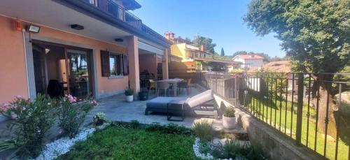 a balcony of a house with a table and chairs at Casa Vista Mare in Muggia