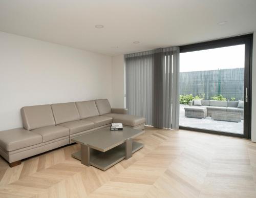 a living room with a couch and a table at MARVEL apartamentai in Kaunas