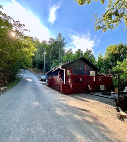 a red and black building on the side of a road at Smores Retreat - Minutes from PF Parkway! Hot tub and fire pit! in Pigeon Forge