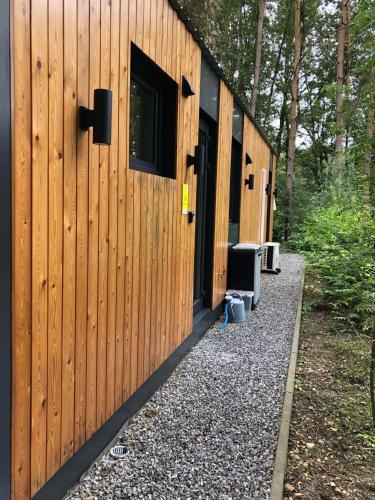 a row of wooden buildings with a television outside at Vakantiewoning Mystiek in Zutendaal