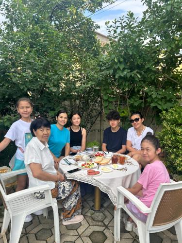 a group of people sitting around a table at Guesthouse TEA in Kutaisi