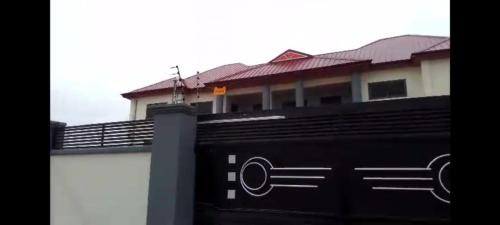 a view of a building from the top of a fence at Purple Springs Elmina #1 in Esamang