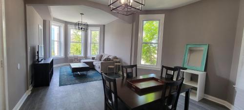 a living room with a table and a dining room at Chicago Avenue Inn in Chicago