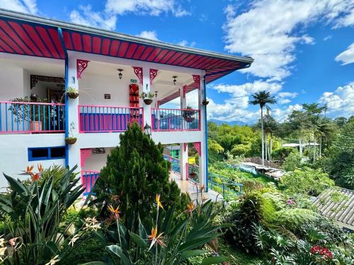 a colorful house with a balcony at Hotel El Jardin in Salento
