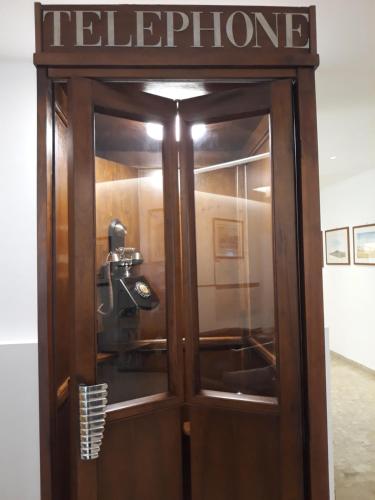 a telephone booth with a pay phone on it at Hotel Minerva in Siena